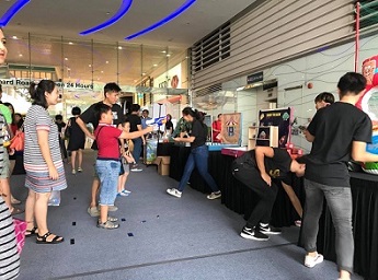 Attendees participating in carnival and sports related game stalls
